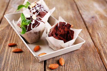 Tasty cupcakes with nuts on table close-up
