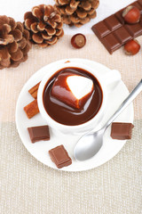 Cup of hot chocolate on table, close up