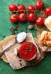 Homemade tomato juice in glass, spices and fresh tomatoes
