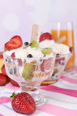 Fresh fruits salad with ice cream in bowls and juice