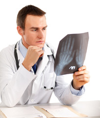 Doctor looking at x-ray on white background