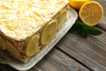 Tasty lemon cake on table at home