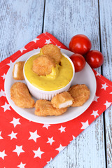 Chicken nuggets with sauce on table close-up