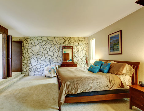 Beautiful bedroom interior with rock wall