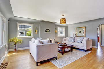 Light grey living room with white sofas