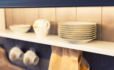 White plates and dinnerware in a cupboard