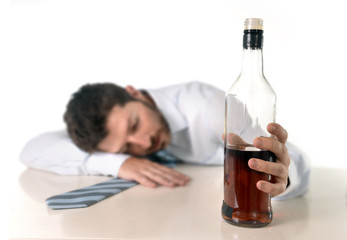 drunk businessman sleeping wasted with whiskey