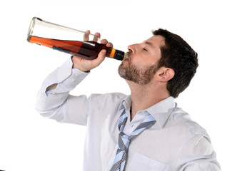 businessman in loose tie  getting drunk with whiskey bottle