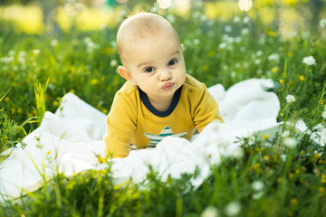 little child lying on a diaper the grass