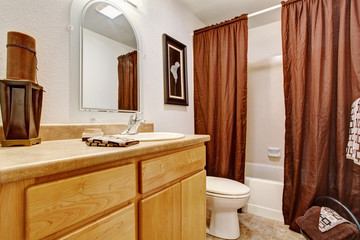 White bathroom interior with honey vanity cabinet