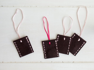 brown stitched felt envelopes with pink ribbons