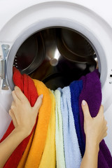 woman taking color clothes from washing machine