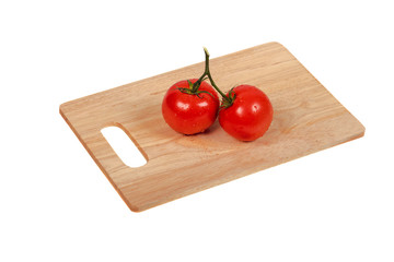 tomatoes on a cutting board on an isolated background top view