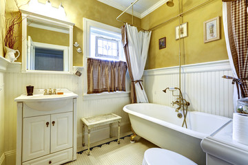 White and yellow antique bathroom interior