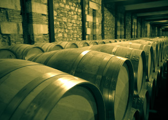 Aged photo of winery with  many wooden barrels © JackF
