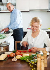 happy mature couple cooking healthy food