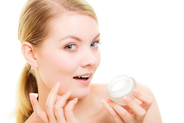 Skin care. Girl applying moisturizing cream
