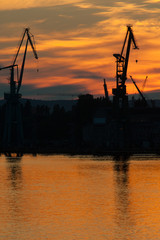 Obraz premium Big shipyard crane at sunset in Gdansk, Poland.