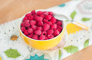 Raspberries on wooden table. Healthy food