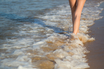 Young woman walking on the beach
