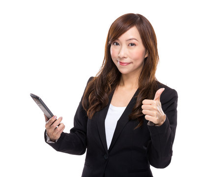 Asian businesswoman with cell phone and thumb up