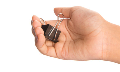 Female hand holding binder clip over white background