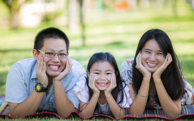 Happy asian mother, father and daughter