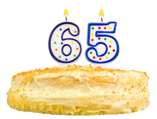birthday cake with candles number sixty five isolated on white