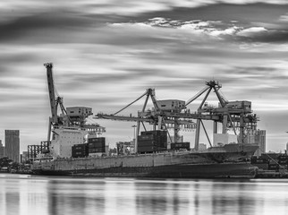Fototapeta na wymiar Container Cargo freight ship with working crane
