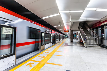 Moving train in subway station