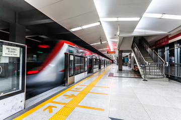 Moving train in subway station