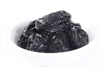 Dried plums in white dish