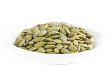 pumpkin seeds on white dish