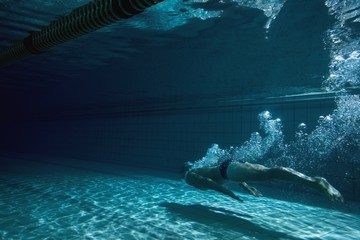 Fit swimmer training by himself