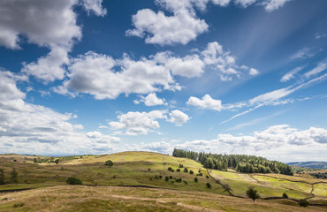 Fototapeta premium Cloudy sky over English countryside in Cumbria, UK.