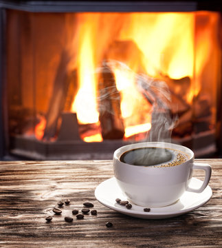 Cup of hot coffee on a old wooden table.