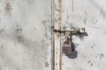 Metallic steel padlock rustic door