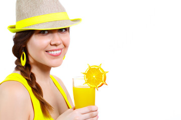 Portrait of a beautiful girl in a hat with orange juice