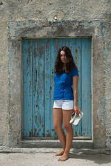 Young girl  near an old wooden door