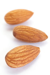 close - up almond seeds  on white