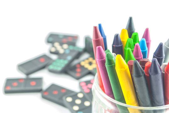 A stack of colorful crayons on an isolated white background