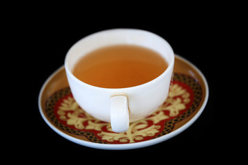 Cup of black tea isolated on black background