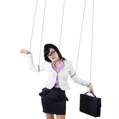 Businesswoman controlled by strings isolated