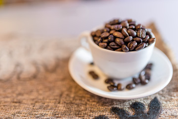 Cup with coffee beans on a saucer