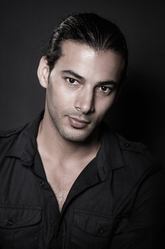 Portrait of young elegant man in the black shirt