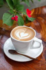 Cup of latte coffee on wooden