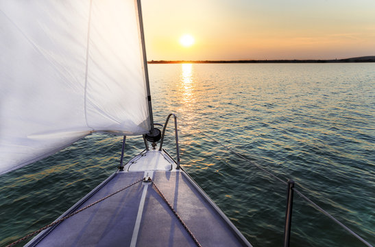 Fototapeta Sailing to the sunset with a luxury yacht.