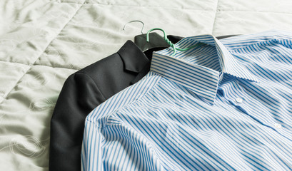 Men's classic shirts and suit on the bed
