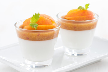 dessert with cream and apricot jelly in glasses