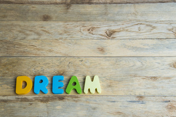 Colorful wooden word Dream on wooden floor2